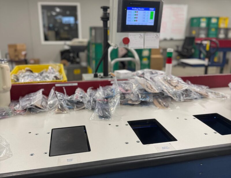 11 Warehouse sorting station used for counting, relabeling, and organizing bagged inventory for return processing.