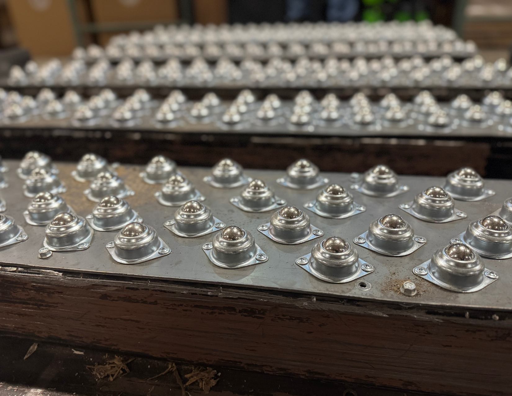 custom-rolling-surface-warehouse-efficiency Closeup of a custom rolling surface with ball transfer units, designed to make warehouse stocking faster and easier.